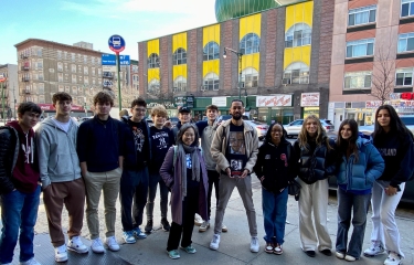 Asad Dandia of New York Narratives in front of Masjid Malcolm Shabazz with a group of high school students after a "Malcolm X's Harlem" tour.