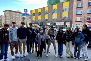 Asad Dandia of New York Narratives in front of Masjid Malcolm Shabazz with a group of high school students after a "Malcolm X's Harlem" tour.