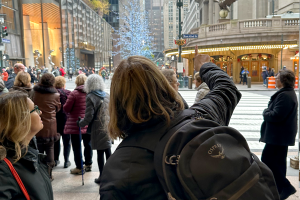 Tour guide pointing out details of Grand Central Terminal to a guest
