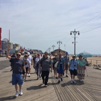 Group of people walking on the Coney Island Boardwalk, Brooklyn, NY