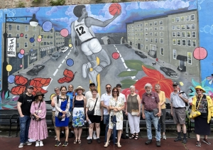 People in front of a mural in Spanish Harlem NYC